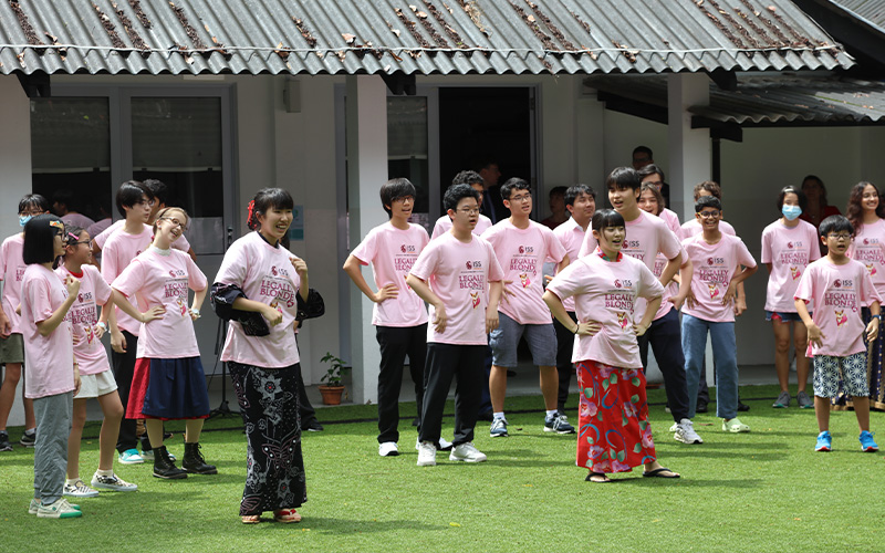 Group of Studends and Teachers standing outside ISS International School.
